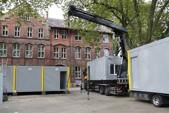 Mithilfe eines Kranes wurden die Module auf dem Schulhof positioniert. Mithilfe eines Kranes wurden die Module auf dem Schulhof positioniert.